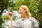 Girl rustic style gather harvest garden autumn day. Farmer pretty blonde with appetite red apple. Woman hold apple