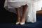 Girl`s bridal gown and legs with shoes