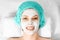 The girl`s face covered with a cosmetic mask, close-up. Skin care, beautician, spa treatments, facial hygiene