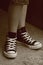 Girl\'s feet in converse sneakers