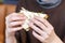 Girl`s hand holding a fresh delicious club sandwich