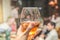 A girl`s hand holds a glass with a drink in a restaurant, menu concept