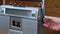 Girl's Hand Twists and Presses the Buttons on the Retro Radio Tape Recorder.