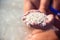 Girl\'s hands holding unusual sand at the sea