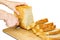 The girl`s hands with a knife sliced Golden bread. Isolated on w