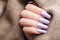 Girl`s hands with a soft purple manicure