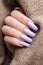 Girl`s hands with a soft purple manicure