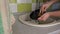 Girl's Hands are Washing Plate with Washcloth and Detergent in Full Sink Slowmo