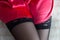 The girl`s legs in black stockings, close-up,