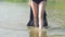 Girl\'s legs going on the water. Slowly