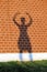 Girl\'s shadow on a red brick wall