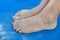 Girl sandy feet on sunbed close