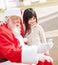 Girl And Santa Claus Taking Selfportrait Through