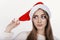 Girl in santa hat looking sideways and thinking
