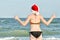 Girl in Santa hats with the inscription New Year on the back on