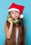 Girl in Santas hat calling by phone