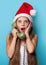 Girl in Santas hat calling by phone