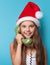 Girl in Santas hat calling by phone