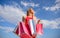 Girl satisfied with purchases. Woman red dress carries bunch shopping bags blue sky background. Feel free buy everything