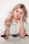 Girl with scales in her hands on a light background makes a decision, weighs the arguments