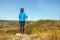 Girl with scandinavian sticks on top of the mountain.