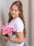 Girl schoolgirl with bouquet of flowers.