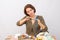 Girl with scissors cuts the decorative ribbon around the table with needlework