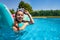 Girl with scuba mask swim on matrass in the pool