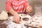 Girl sculpts dumplings, the dough is in the hands of a child