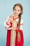 Girl with a scythe in Russian folk costume