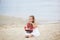 Girl on the sea with a ship. Close-up portrait of the girl`s face. little girl wait boat with scarlet sail. Girl on the beach in a