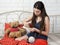 Girl seamstress engaged in embroidery on the bed