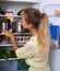 Girl searching food on refrigerator shelves