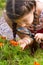 Girl sees flowers through magnifying glass