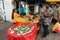 A girl selling deep fried Indian snacks at a roadside hawker stall in Little India