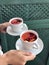 Girl serves fruit tea in cups