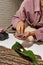 Girl set up oil, bowl with water, tree bark, leaf