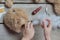 A girl sews a bear toy. Handicraft with children. Child fills the toy with a sintepon.