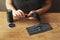 Girl sews medical masks on a wooden table