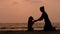 Girl shaking hands with her dog