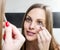 Girl shaping eyebrows with tweezer