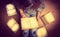 Girl in a shirt holding a book sitting on the floor around her spread open books close up retro toning