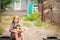 Girl in shirt and shorts with a basket of fruit. Girl farmer with apples and grapes. Concept of ecological food, person