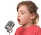 Girl in shirt singing in microphone, half body