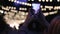 Girl shoots on a smartphone night lights gerland Christmas and background