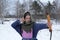 A girl shoots in the winter from a bow at the festival of medieval Vikings