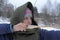 A girl shoots in the winter from a bow at the festival of medieval Vikings