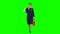 Girl with shopping packages in her hands is walking along the street. Green screen