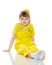 Girl with a short bangs on her head and bright yellow overalls.