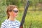 Girl with a shotgun in an outdoor